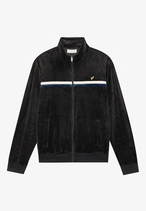 Zwarte zip-up jas van zacht fluweel materiaal, met een witte en marineblauwe horizontale streep over de borst, zijzakken en geribbelde manchetten.