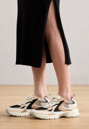 Suknelės su tekstūromis, juoda tinkleliais, šviesiai rudos odos akcentais ir balta pado. Savybės apima kontrastingas spalvas ir raištelių dizainą, užtikrinantį tvirtą prigludimą.