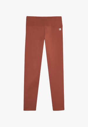 Leggings color ruggine realizzati in un tessuto liscio e elastico, dotati di una ampia vita elastica e di un piccolo logo sul lato dell'anca.