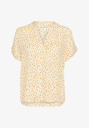 Blouse à manches courtes en tissu léger et semi-transparent. Elle présente un décolleté en V et un motif à pois jaunes et oranges sur fond blanc.