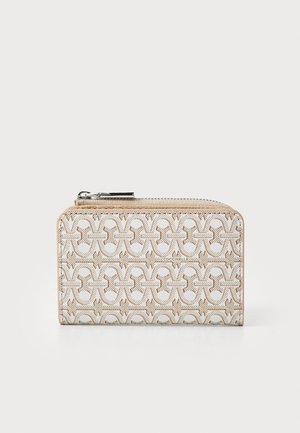 Zip-around wallet in light beige with embossed geometric pattern, featuring light brown accents and silver-tone hardware. Smooth leather finish.