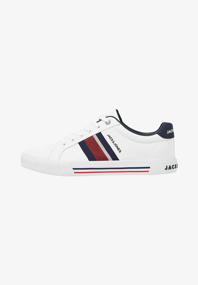 White canvas sneaker with navy accents, red and blue stripes, round toe, lace-up front, and a textured rubber sole. Brand logo visible.