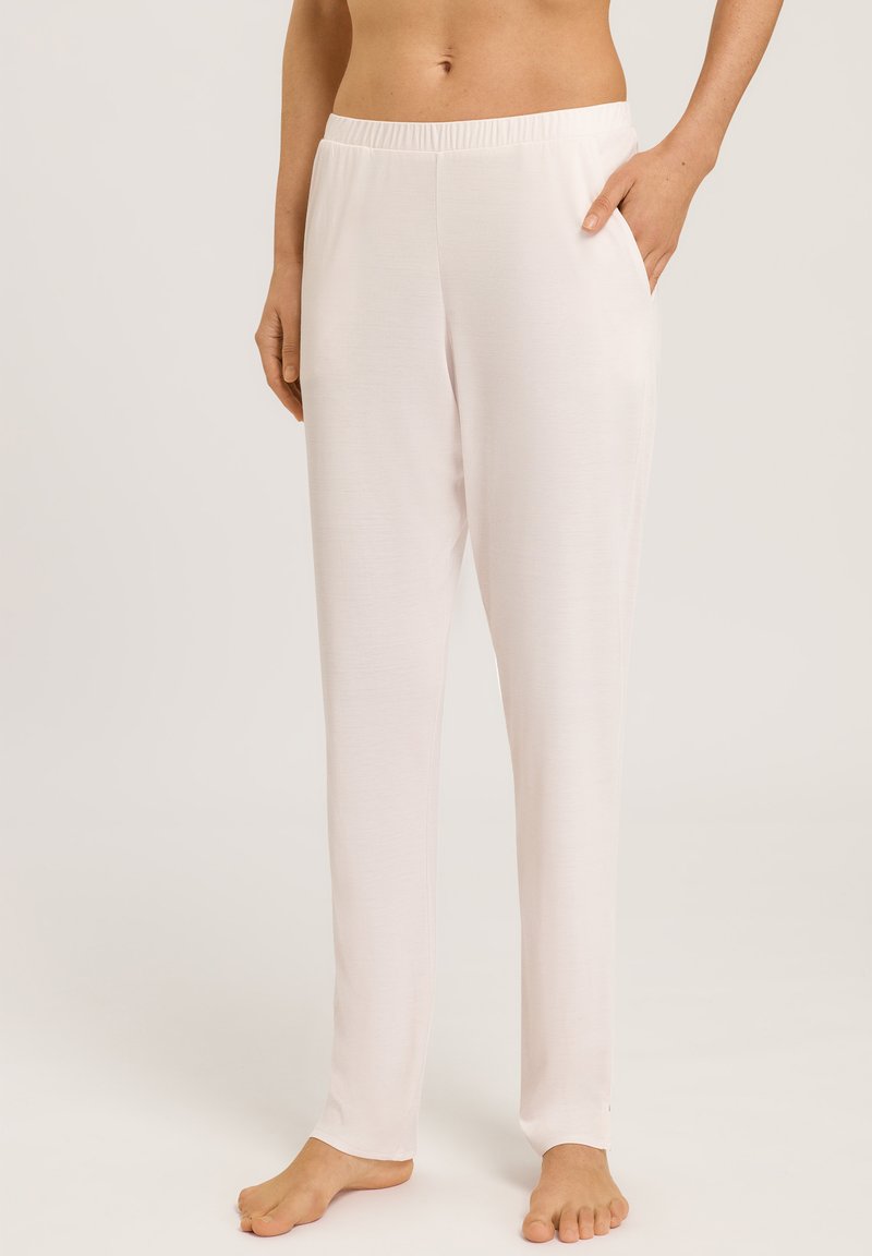 Pantalones de lounge de tela suave en rosa claro, con cinturilla elástica y bolsillos laterales, que presentan un diseño de pierna recta y una textura suave.