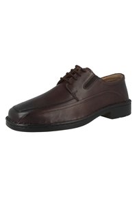 Chaussure en cuir marron avec un bout arrondi, des lacets, des panneaux élastiques sur les côtés et une semelle en caoutchouc noir. Présente des coutures visibles le long des bords.