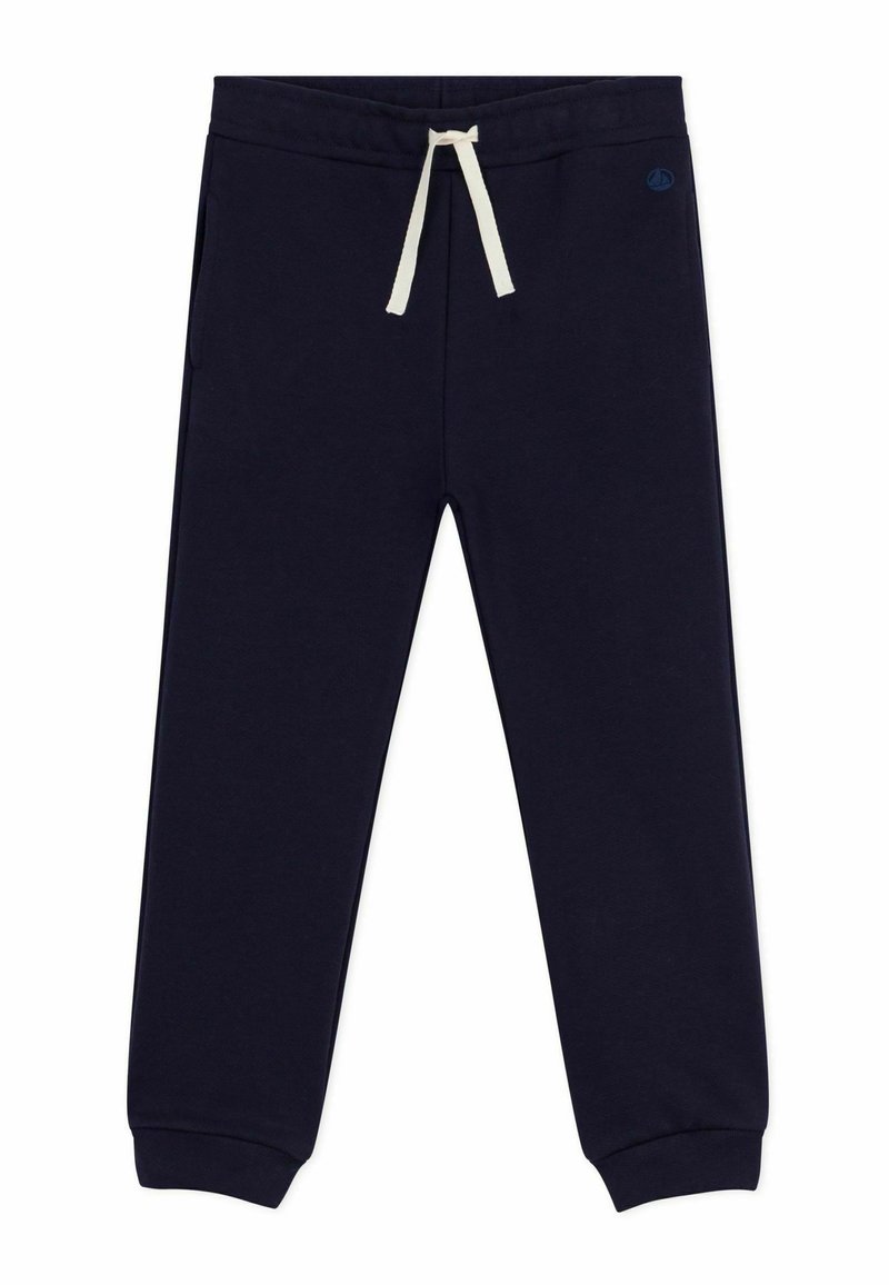 Pantalons de survêtement bleu marine en tissu doux, avec une taille élastique dotée d'un cordon de serrage crème et des poignets fuselés. Deux poches latérales incluses.