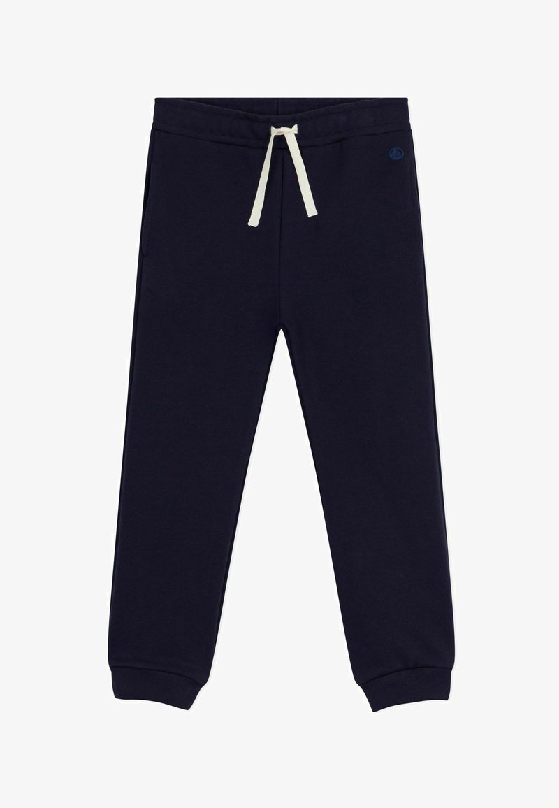Pantalons de survêtement bleu marine en tissu doux, avec une taille élastique dotée d'un cordon de serrage crème et des poignets fuselés. Deux poches latérales incluses.