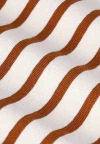 Striped fabric with wavy lines, featuring alternating brown and cream colors. Texture appears ribbed, emphasizing the pattern and material quality.