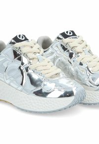 Silver mirrored sneakers with textured outsole, cream laces, contrasting black logo on the tongue, and padded collar for comfort.