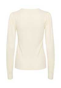 Ribbed long-sleeve sweater in soft cream with a fitted shape, featuring a round neck and slightly puffed shoulders.
