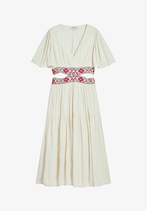 Kremo spalvos suknelė su trumpomis plasdančiomis rankovėmis, V formos iškirpte ir raštuota juosmens detalė, puošta rožinėmis ir raudonomis siuvinėjimo detalėmis. Platėjanti sijonas.