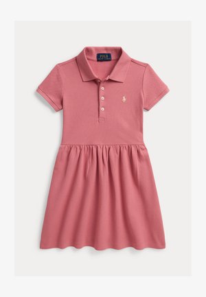 Polo dress in soft pink, featuring a collared neck, button closure, and a flared, textured skirt. Includes small logo accent on chest.