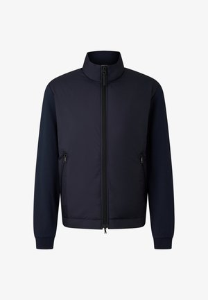 Navy jacket featuring a padded front, contrasting knit sleeves, high collar, and zippered pockets on either side. Smooth texture throughout.