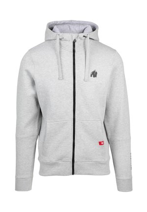 Grijze rits-hoodie van zachte stof, met een zwart logo op de borst, voorzakken en een contrasterende zwarte rits.
