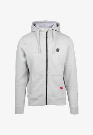 Grijze rits-hoodie van zachte stof, met een zwart logo op de borst, voorzakken en een contrasterende zwarte rits.