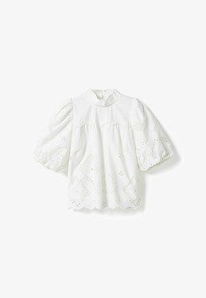 Balta palaidinė su pūstomis alkūnės ilgio rankovėmis, aukštu raukšlėtu apykakle ir akių siuvinėjimu geometriniais raštais ant rankovių ir apačios.