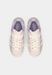 Light pink synthetic sneakers with white stripes, cream laces, and a lavender interior. Rounded toe and padded collar for comfort.