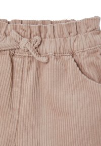 Pink corduroy pants with a textured ribbed pattern, featuring an elastic waistband and drawstring, and a side pocket detail.