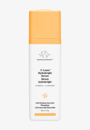 White bottle with an orange cap, featuring black text including "C-Luma Hydrabright Serum," and a graphic of a stylized sunburst at the bottom.