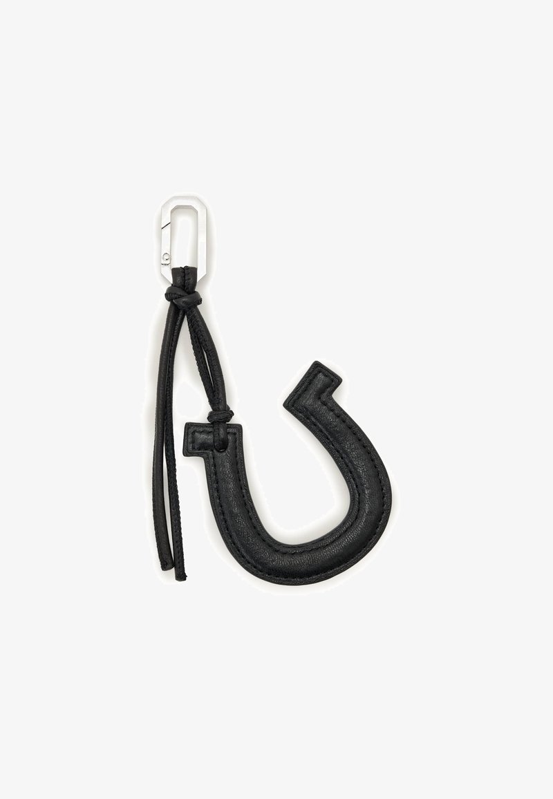 Svart lädernyckelring i en böjd krokform, med ett silverfärgat metallklämma och en flätad läderrem. Mjuk textur med sydda detaljer.