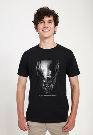 Black cotton t-shirt featuring a graphic design of an alien skull with the text "IN SPACE, NO ONE CAN HEAR YOU SCREAM" beneath it.