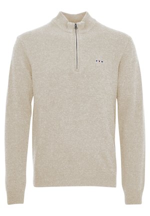 Beige színű, cipzáros nyakú pulóver texturált kötött anyagból. Fekete cipzárral és egy kis logóval rendelkezik, amely piros, fehér és kék csíkokból áll, és a mellrészen található.