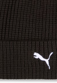 Black ribbed knit fabric with a white Puma logo embroidered on the lower right corner.