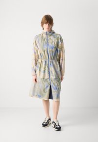 Lightweight, patterned zip-up coat in pastel colors with a cinched waist, long sleeves, and a hood, featuring an open front and side slit.