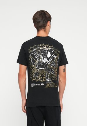 Black cotton t-shirt featuring a graphic of a character in white and gold on the back, with a textured spiderweb design around it.