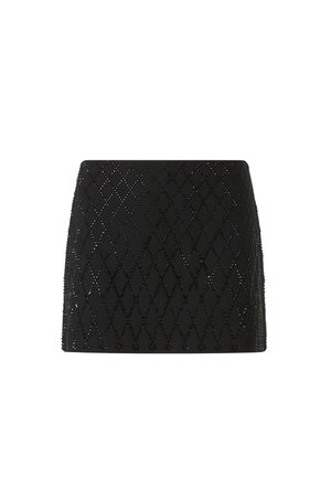 Mini-jupe noire avec motif de découpes en forme de losanges et détails texturés. Conçue dans un tissu léger et respirant.