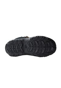 Black hiking boot sole with deep tread pattern for traction, textured rubber material, and distinctive branding visible on the outsole.