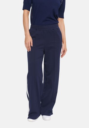 Navy blue trousers with a relaxed fit, featuring a drawstring waistband and white side stripes. Made from soft, stretchy fabric.