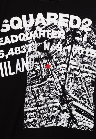 Maglietta nera con grafica bianca di una mappa con coordinate e testo "MILANO", evidenziata da un dettaglio di foglia d'acero rossa.