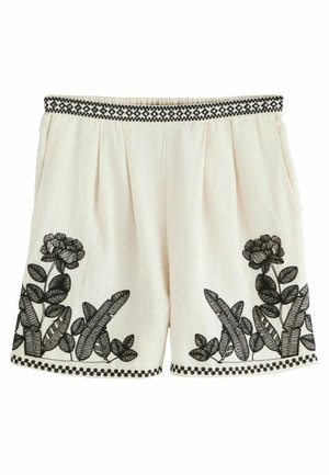 Weiße Leinen-Shorts mit schwarzer Blumenstickerei am Saum und an den Seiten, einem schwarzen gemusterten Bund und seitlichen Taschen.