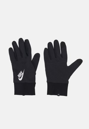Black Nike gloves made of stretchy material, featuring a soft texture, a fitted design, and a white logo on the wrist area. Touchscreen fingertips included.