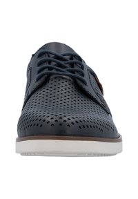 Navy blue perforated leather shoes with navy laces, brown accents, and a white sole. Features a rounded toe and textured surface.