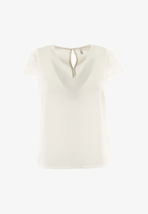 Valkoinen paita, jossa on V-muotoinen kaula-aukko ja pitsiset lyhyet hihat. Takana on avaus, joka muistuttaa avaimenreikää. Sileä pinta, kevyt kangas.