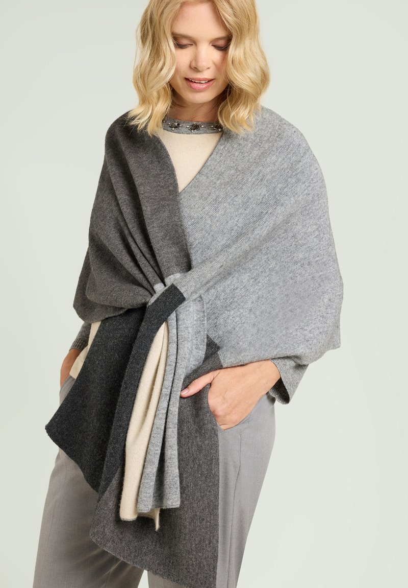 Strikket poncho i forskellige nuancer af grå, med et draperet design og et twist-detalje foran samt en blød tekstur.