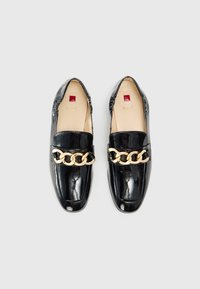Black patent leather loafers with a gold chain accent on the strap. Rounded toe and smooth texture. Brand logo visible inside.