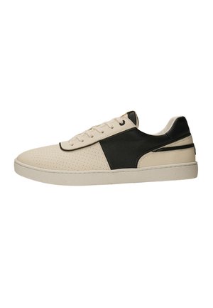 Low-top sneaker in beige and black with perforated toe, lace-up front, and flat white sole, shown in side profile.