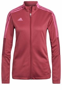 Röd träningsjacka med hög krage, full dragkedja och rosa detaljer. Har tre rosa randiga linjer på axlarna och meshpaneler.