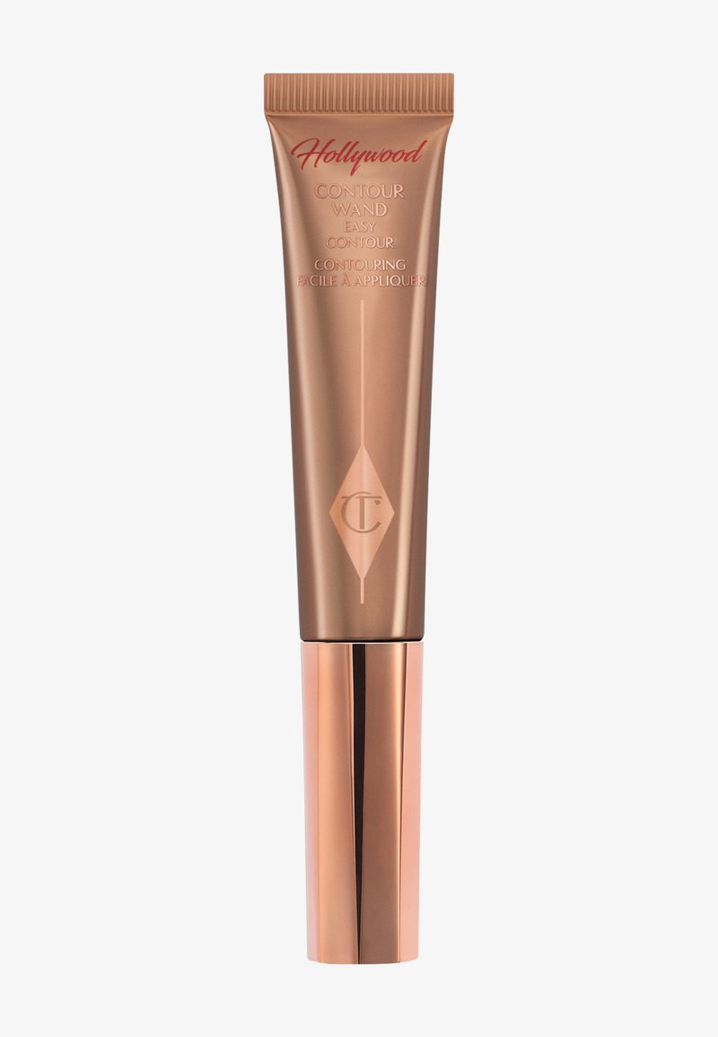 Contour wand in a bronze tube with a tapered applicator and embossed logo. Features a glossy metallic cap and smooth, sleek texture.