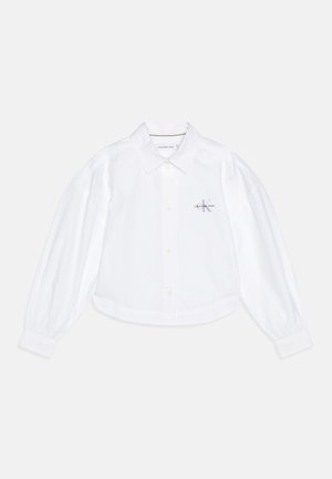 Weißes, kurzes Button-Down-Hemd mit klassischem Kragen, Ballonärmeln und kleinem Calvin Klein-Logo in helllila auf der linken Brust.