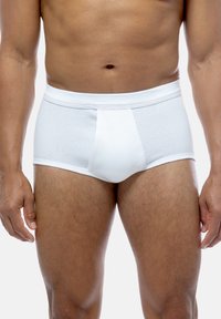 Slip in cotone bianco a coste con vestibilità aderente, dotati di un morbido elastico in vita e una tasca frontale. Design senza cuciture per un comfort ottimale.