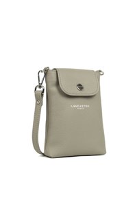 Gray leather crossbody bag with a flap closure, featuring a silver logo and adjustable strap. Compact design with textured surface.