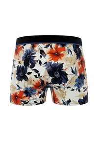 Boxers à motifs floraux avec une taille noire. Présente de grandes fleurs bleues, oranges et crème sur un fond crème. Texture lisse.