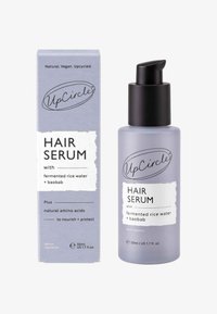 Ett lavendelfärgat hårserum i en frostad glasflaska med en svart pump. Levereras med en matchande kartong med produktdetaljer.