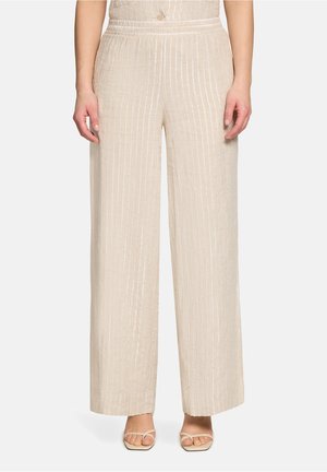 Beige Hosen mit weitem Bein und vertikalen weißen Streifen, hoher Taille, Knopfverschluss, getragen mit beigen Riemchensandalen.