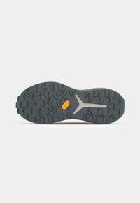 Vibram outsole featuring a rugged, textured gray rubber surface with a yellow logo and triangular tread patterns for traction.