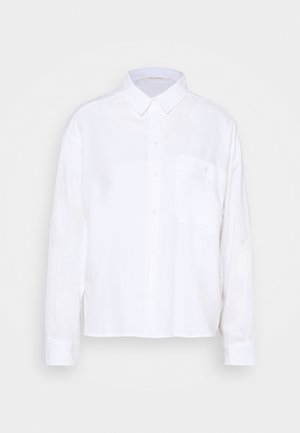 Chemise blanche à manches longues en tissu léger. Dotée d'un col boutonné, d'une poche avant et d'un ourlet droit. Texture lisse.