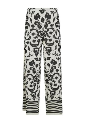 Pantaloni a gamba larga in maglia con motivo floreale nero e motivi a spirale su sfondo bianco, con righe orizzontali nere e bianche all'orlo.